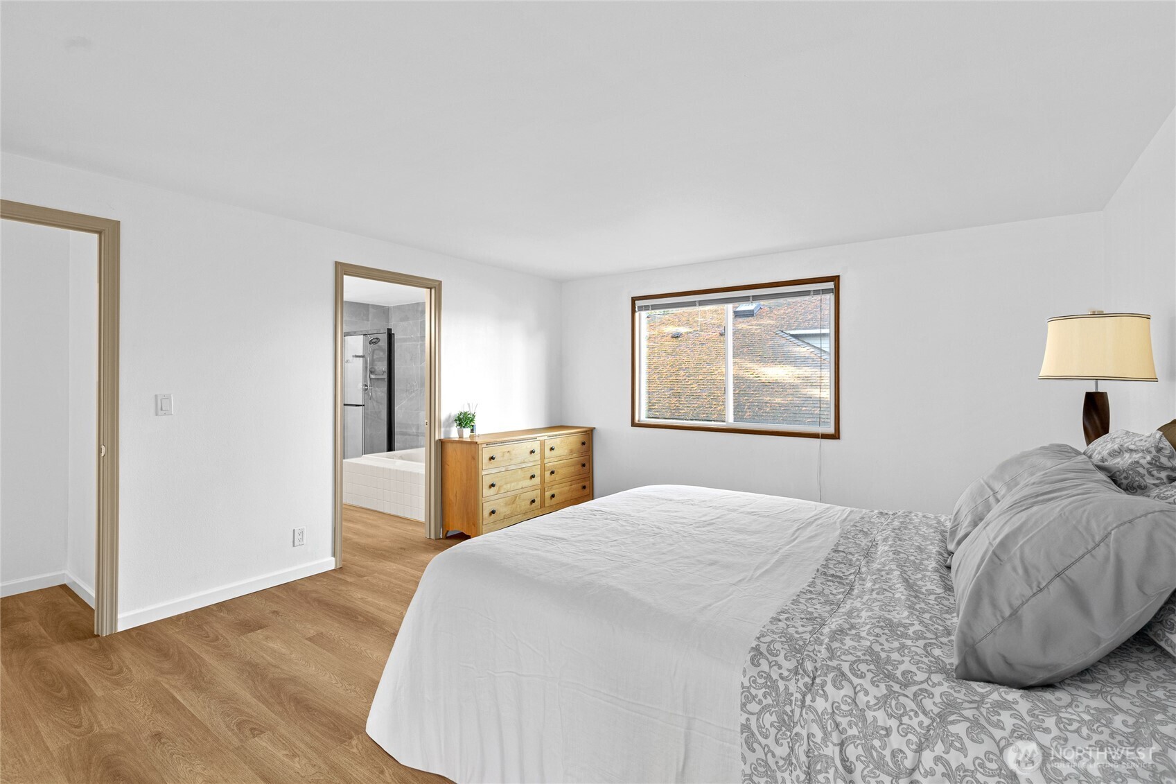 5824 111th Place Southwest Mukilteo, WA 98275 - Photo 22 of 38 a bedroom with a large bed and a painting on the wall