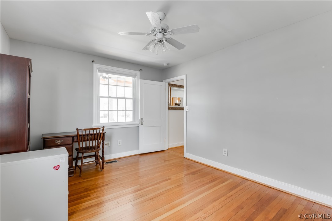 1910 Seddon Road Richmond, VA 23227 - Photo 21 of 39 an empty room with wooden floor fan and windows