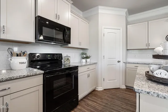 a kitchen with stainless steel appliances granite countertop a stove a microwave and cabinets