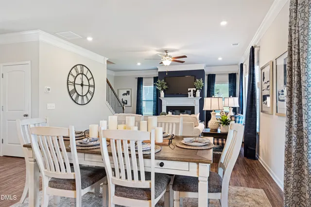 a view of a dining room with furniture a chandelier and wooden floor