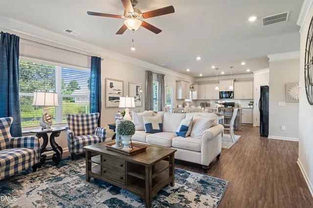 a living room with furniture wooden floor and a table
