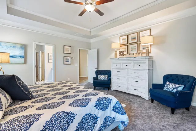 a bedroom with a bed and a chair