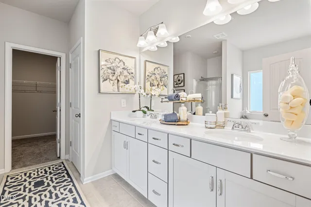 a bathroom with double vanity sink a vanity and a mirror