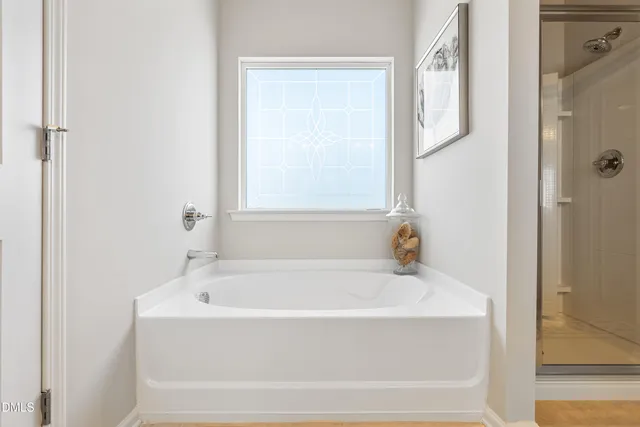 a white bath tub sitting next to a window