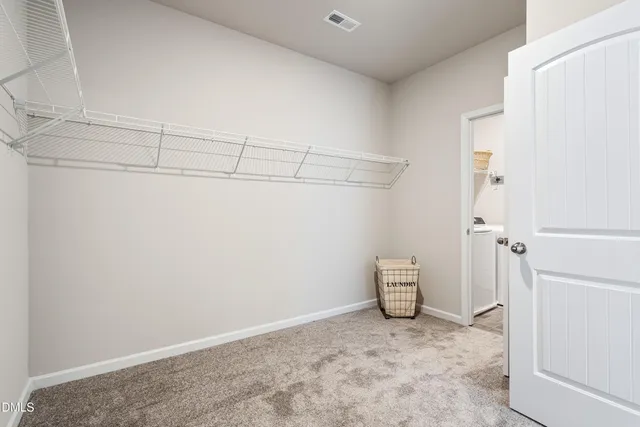 a view of a room with shelf and closet