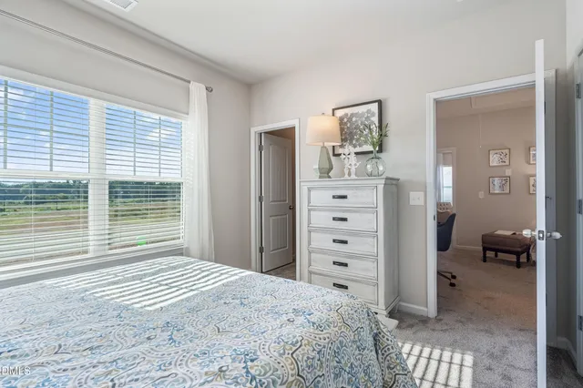 a bedroom with a bed and a dresser