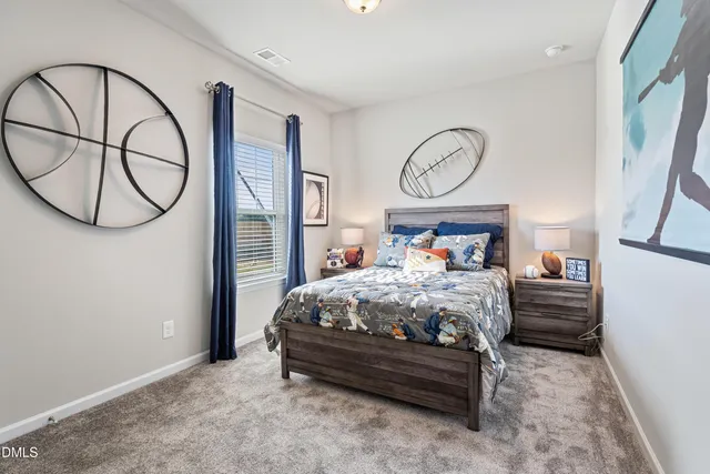 a bed sitting in a room next to a window