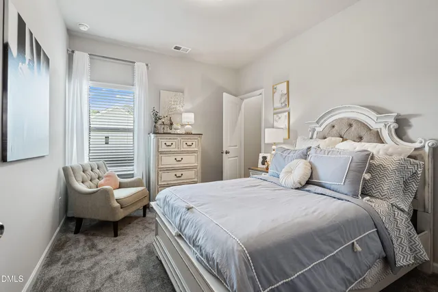 a bedroom with a bed and a couch