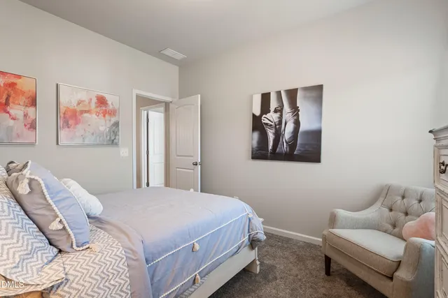 a bedroom with a bed and couch