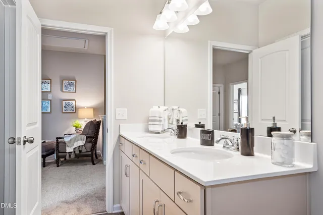 a en suite bathroom with a sink double vanity and a mirror