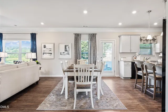 a dining room with furniture and wooden floor