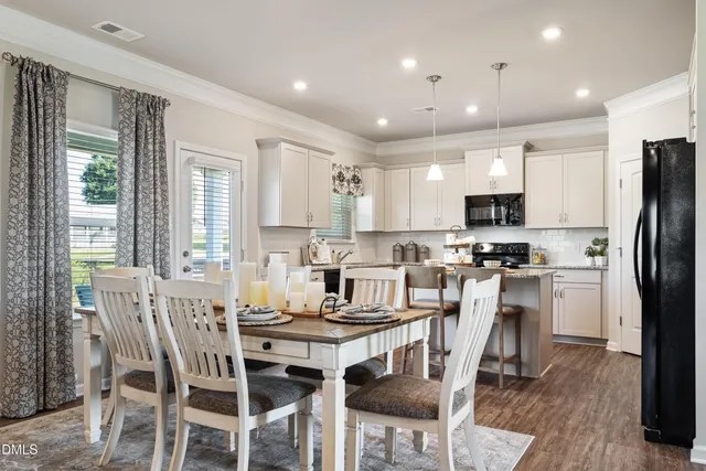 a kitchen with kitchen island white cabinets and stainless steel appliances
