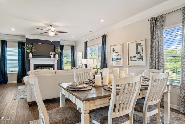 a living room with furniture a fireplace and a table