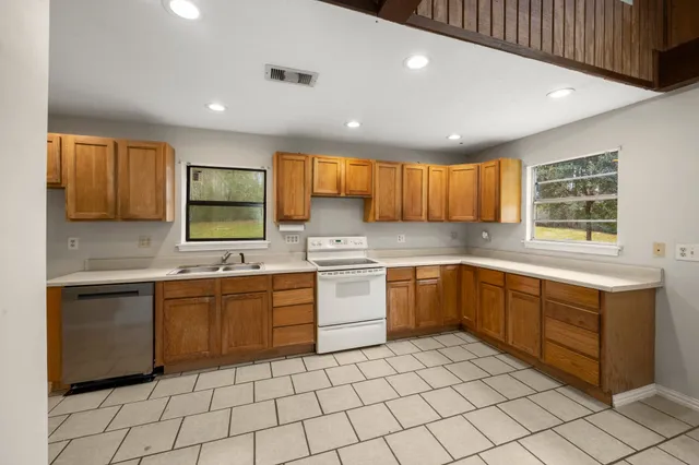 a kitchen with sink cabinets and window