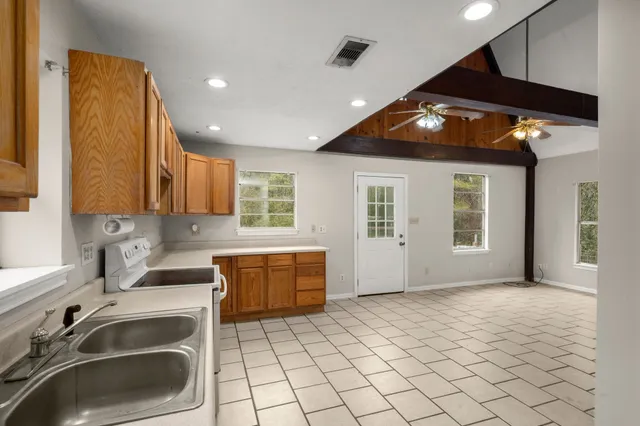 a kitchen with sink cabinets and stove