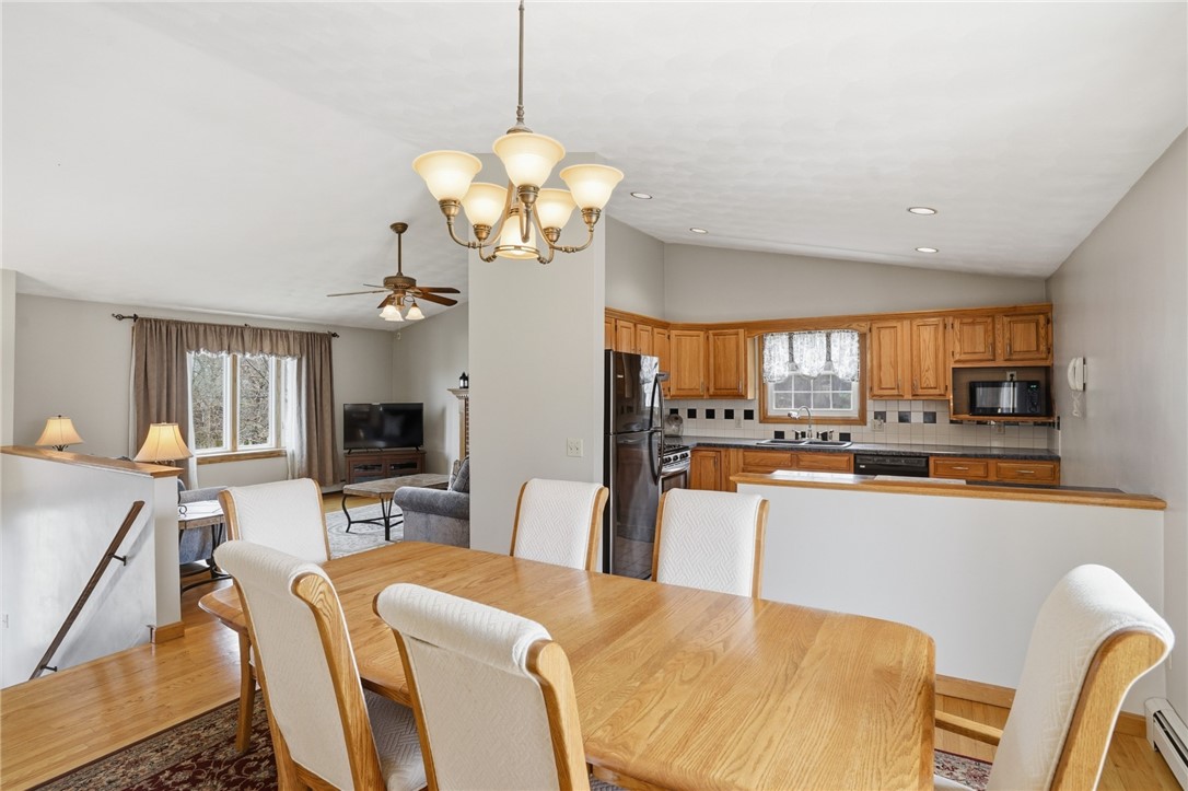 24 Sandy Lane Bristol, RI 02809 - Photo 2 of 27 Dining area open leading to back deck and open to kitchen and living room.