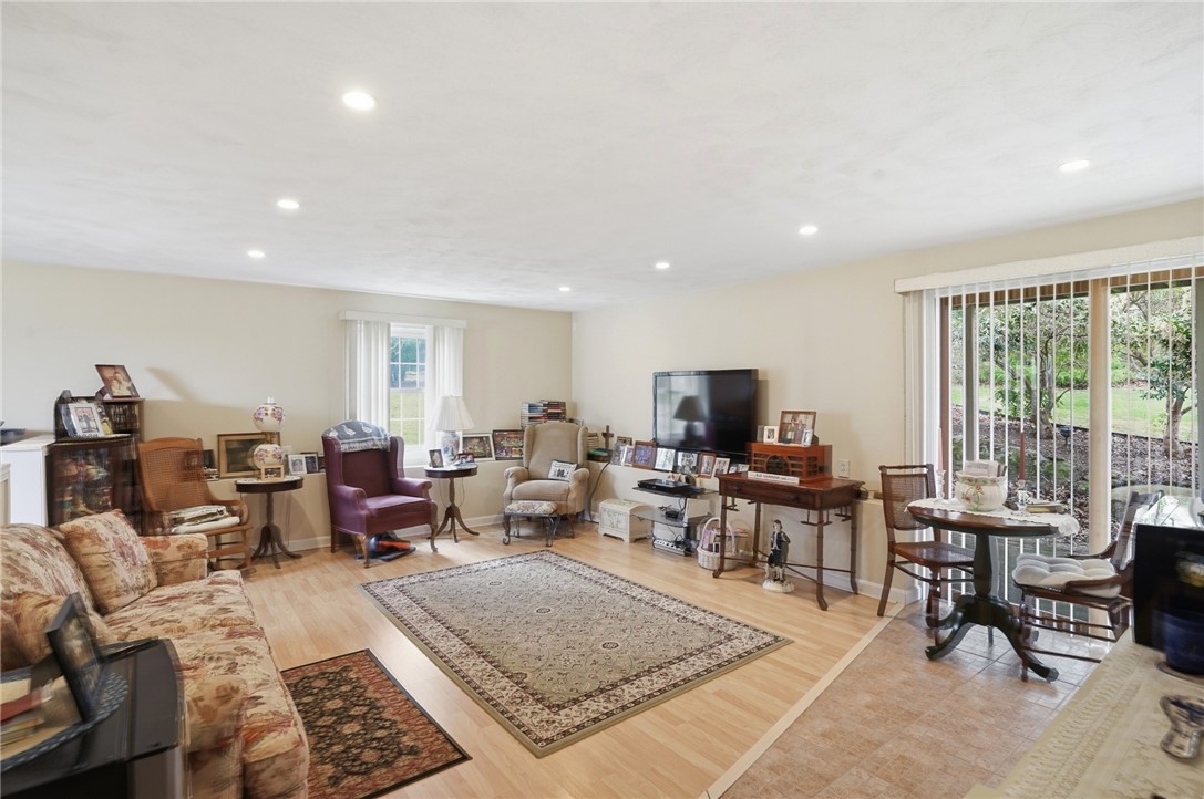 24 Sandy Lane Bristol, RI 02809 - Photo 21 of 27 Lower level family room with bedroom area, half bath and walk out to backyard.