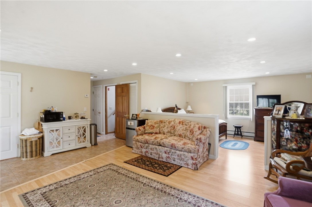 24 Sandy Lane Bristol, RI 02809 - Photo 22 of 27 Lower level family room with bedroom area, half bath and walk out to backyard.
