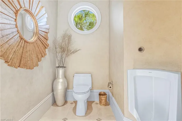 a white toilet sitting next to a shower curtain