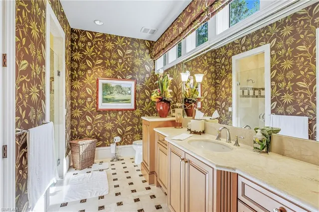 a bathroom with a granite countertop sink a large mirror and a shower