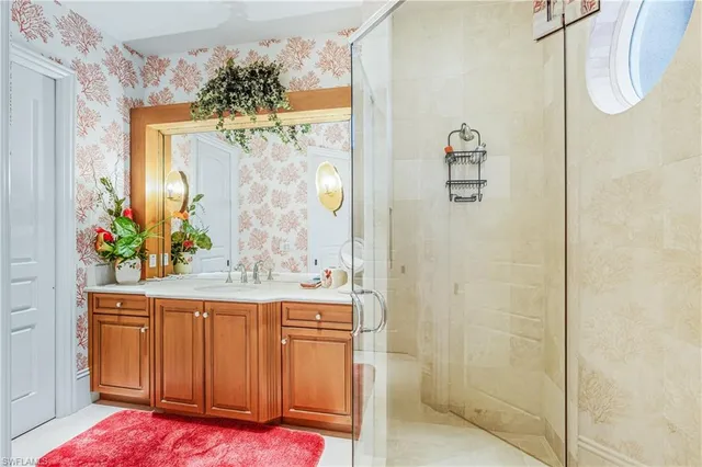 a bathroom with a granite countertop shower a sink and a mirror