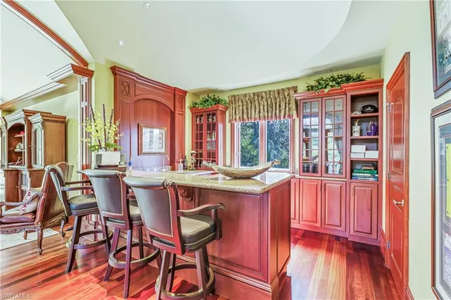 a room with furniture pool table flat screen tv and windows