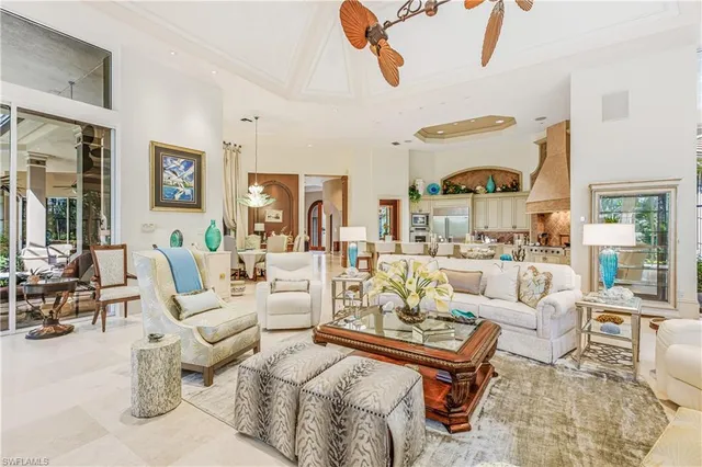a living room with furniture a rug and a chandelier