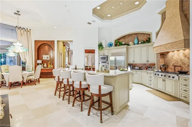 a large kitchen with a large window and view of living room