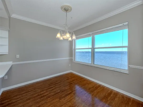 a kitchen with stainless steel appliances granite countertop a refrigerator a stove and a wooden floors