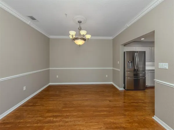 a kitchen with stainless steel appliances granite countertop wooden cabinets granite counter tops and a hard wood floors