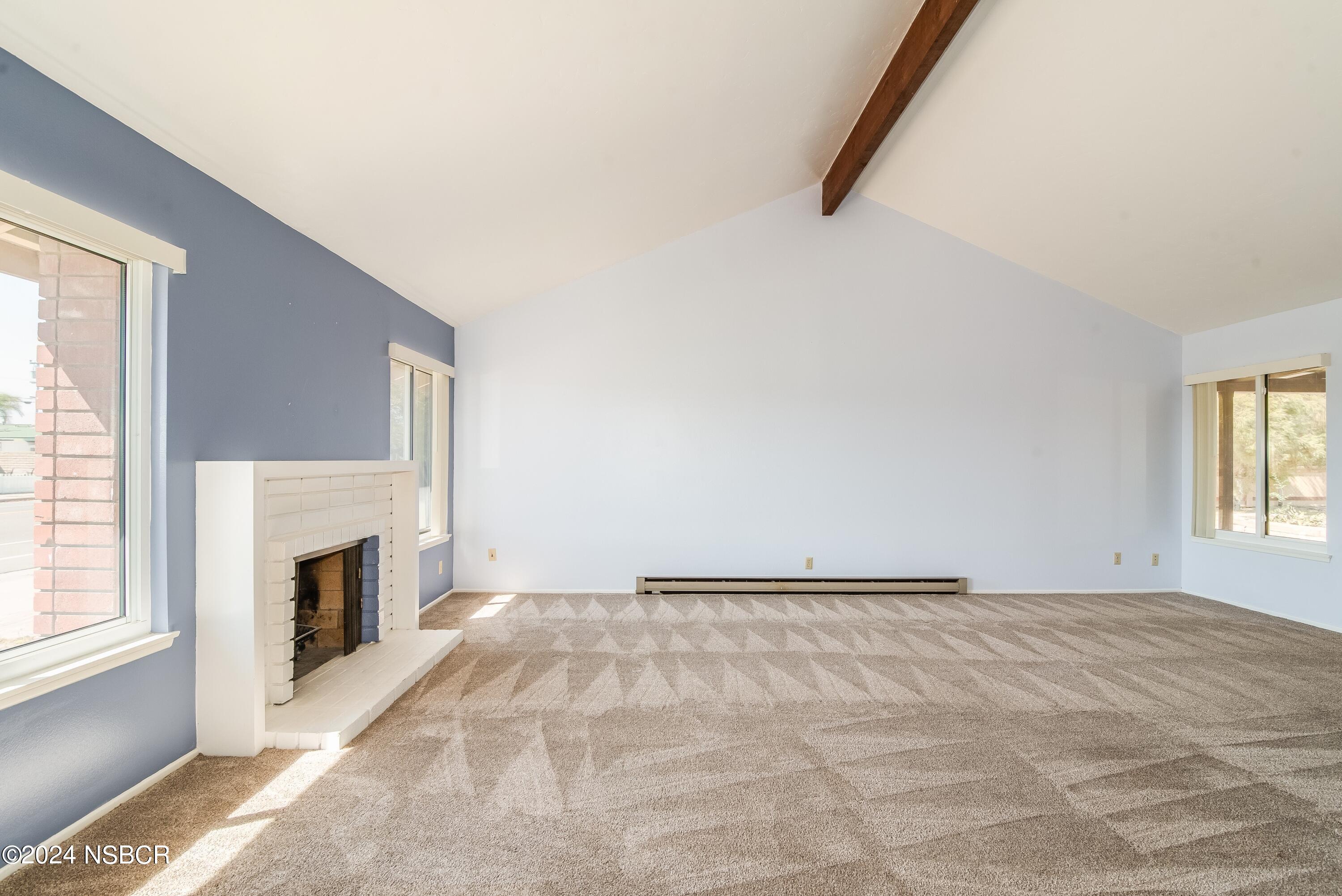 4149 Constellation Road Lompoc, CA 93436 - Photo 13 of 31 a view of an empty room with a fireplace and a window