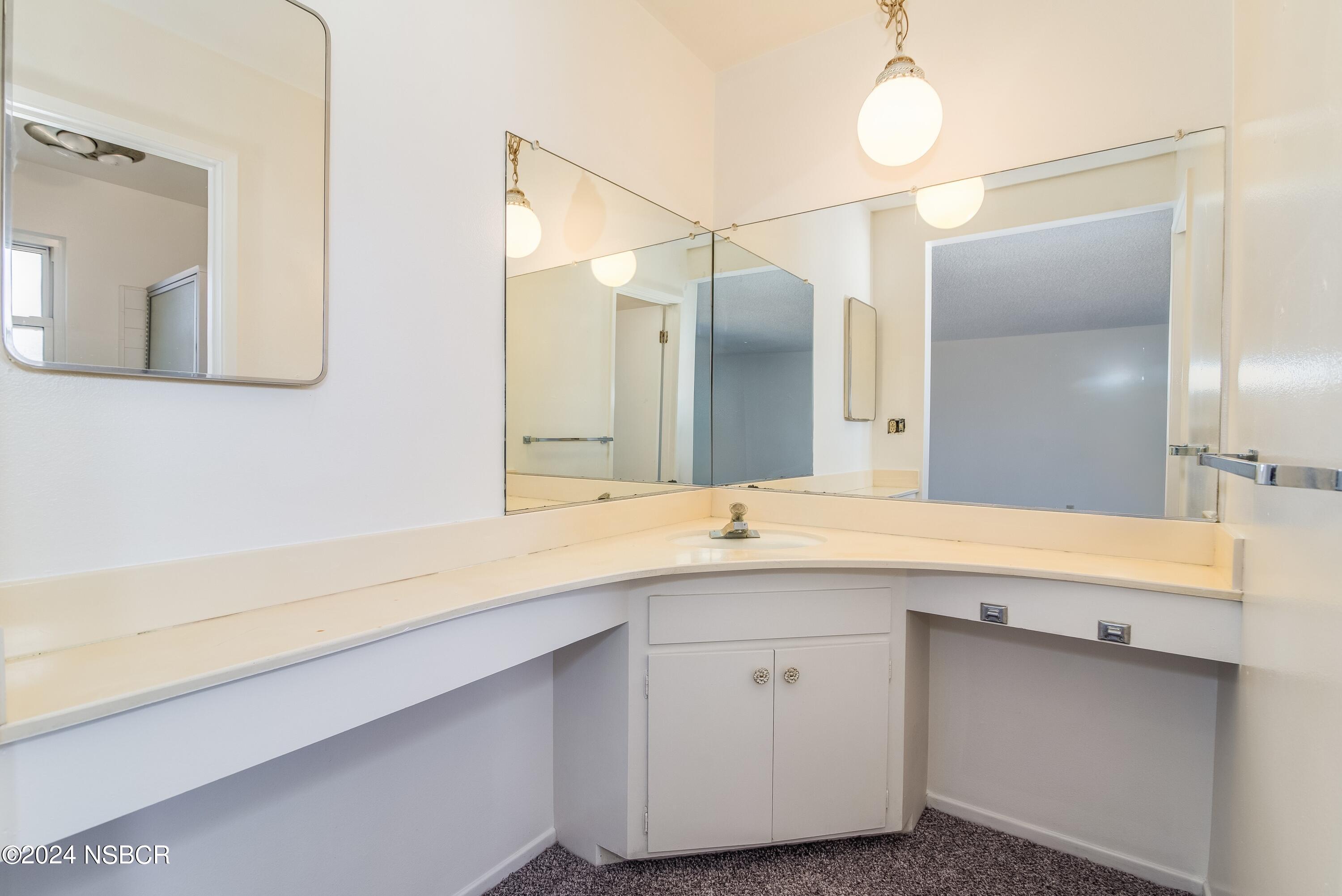 4149 Constellation Road Lompoc, CA 93436 - Photo 17 of 31 a bathroom with a sink and a mirror