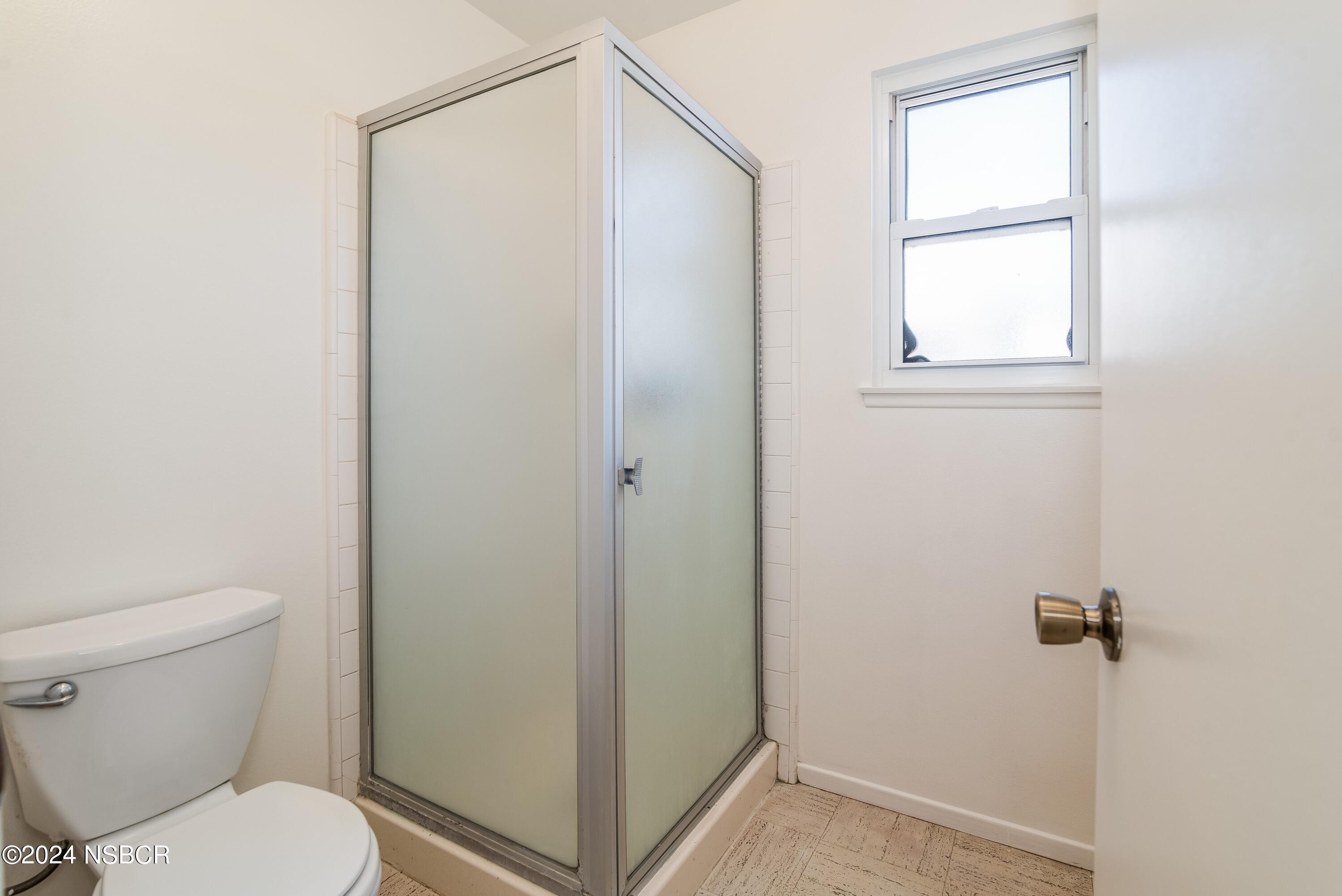 4149 Constellation Road Lompoc, CA 93436 - Photo 18 of 31 a bathroom with a toilet and a shower