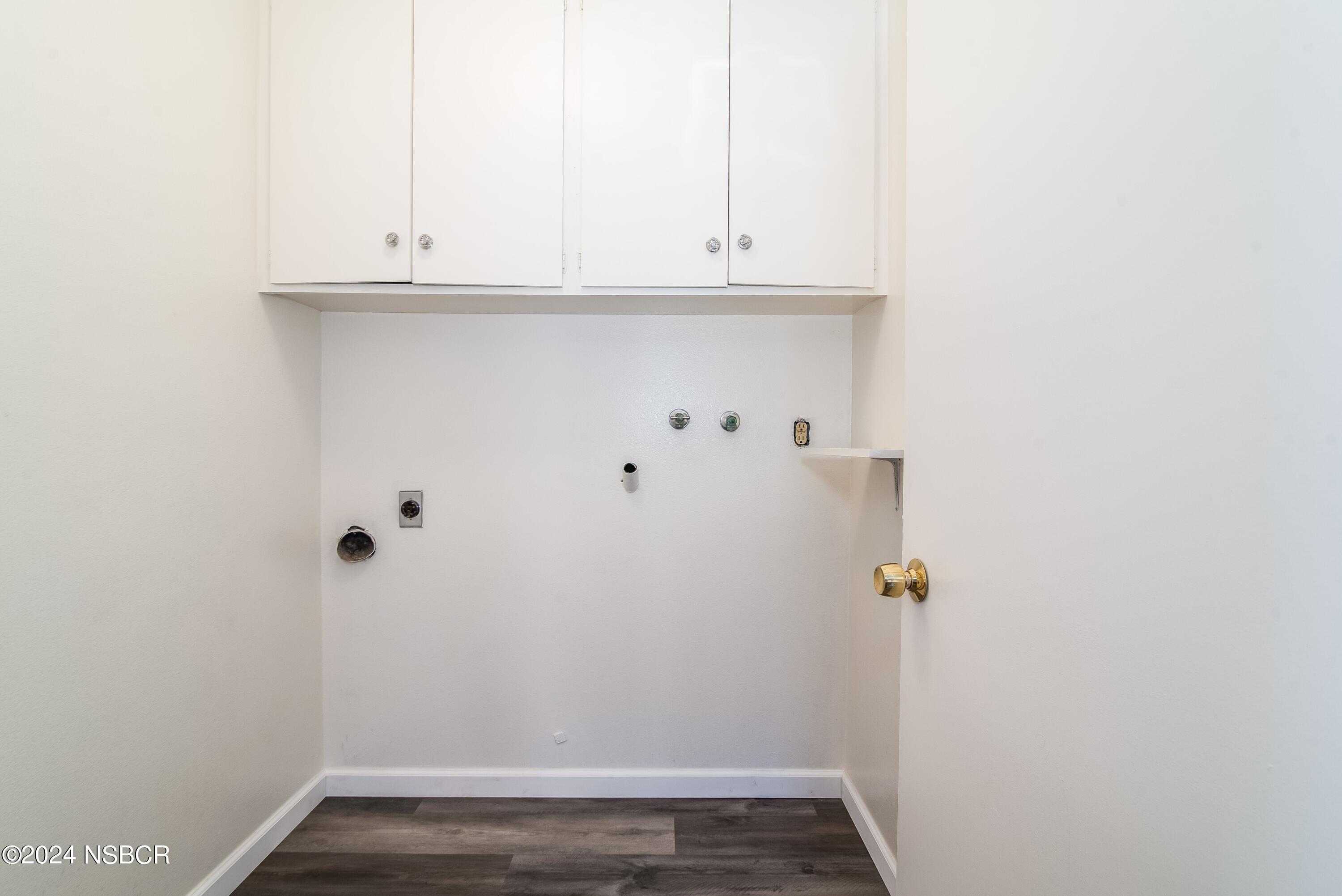 4149 Constellation Road Lompoc, CA 93436 - Photo 19 of 31 a view of cabinets and utility room with wooden floor