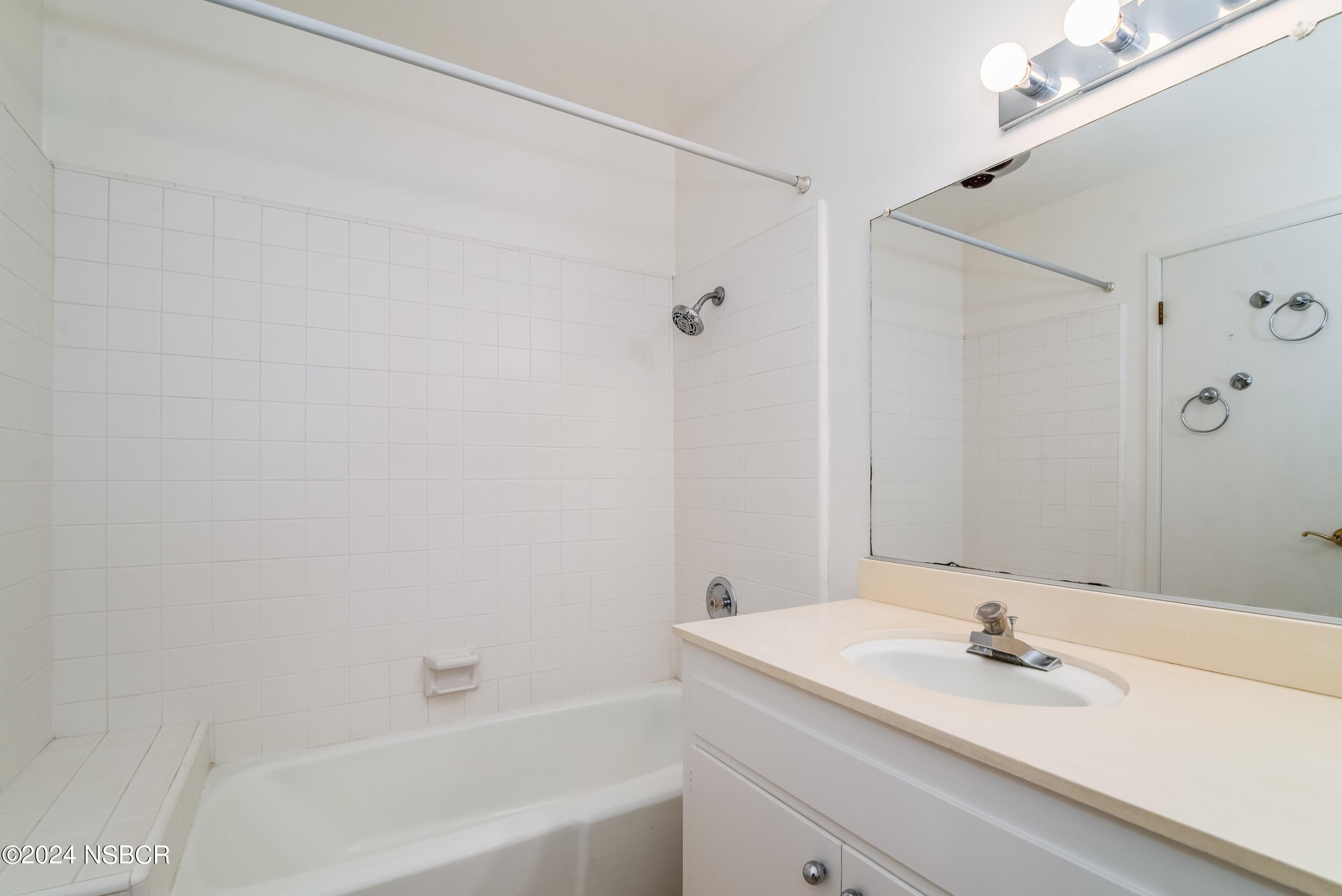 4149 Constellation Road Lompoc, CA 93436 - Photo 23 of 31 a bathroom with a sink and a mirror