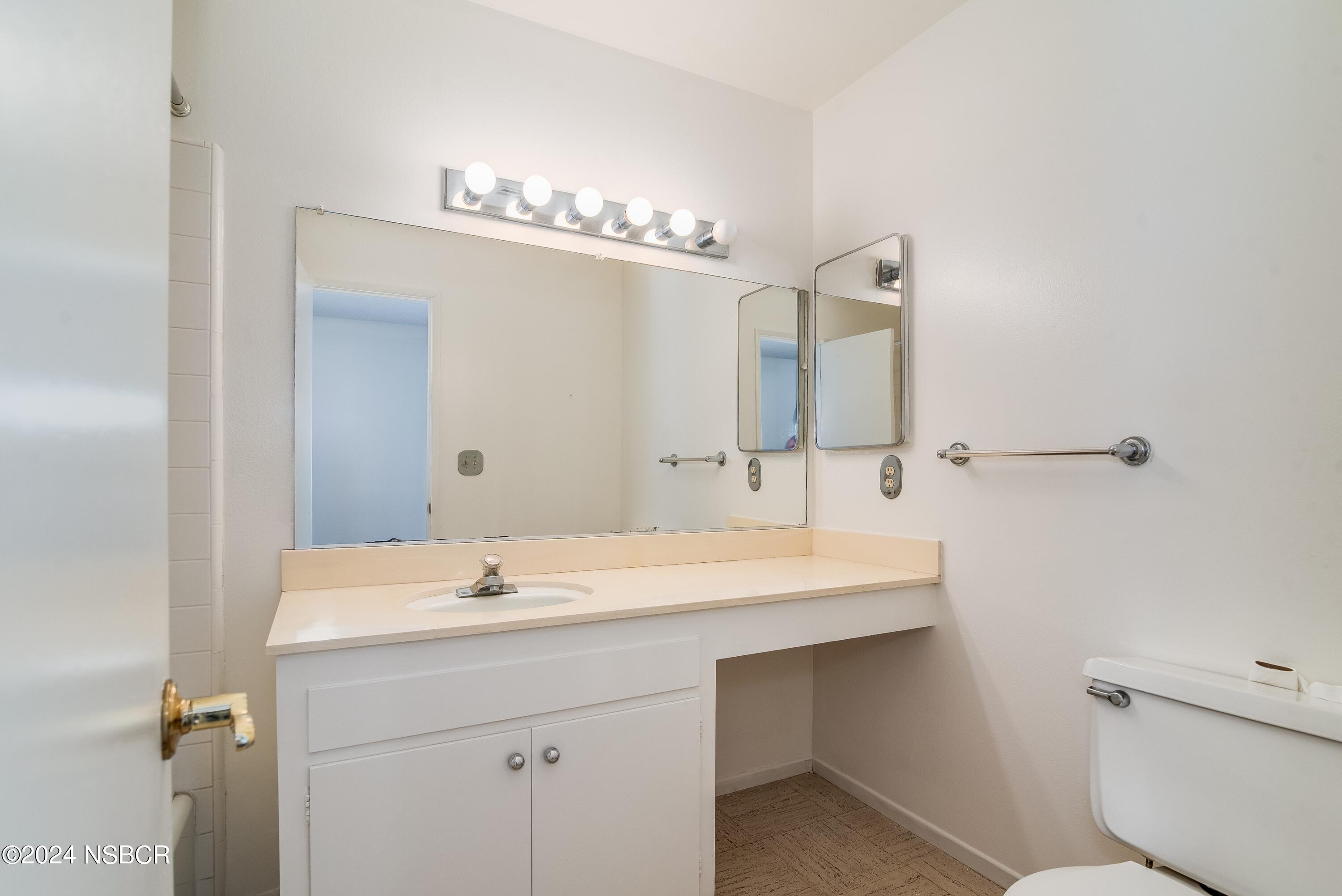 4149 Constellation Road Lompoc, CA 93436 - Photo 24 of 31 a bathroom with a sink a toilet and a mirror