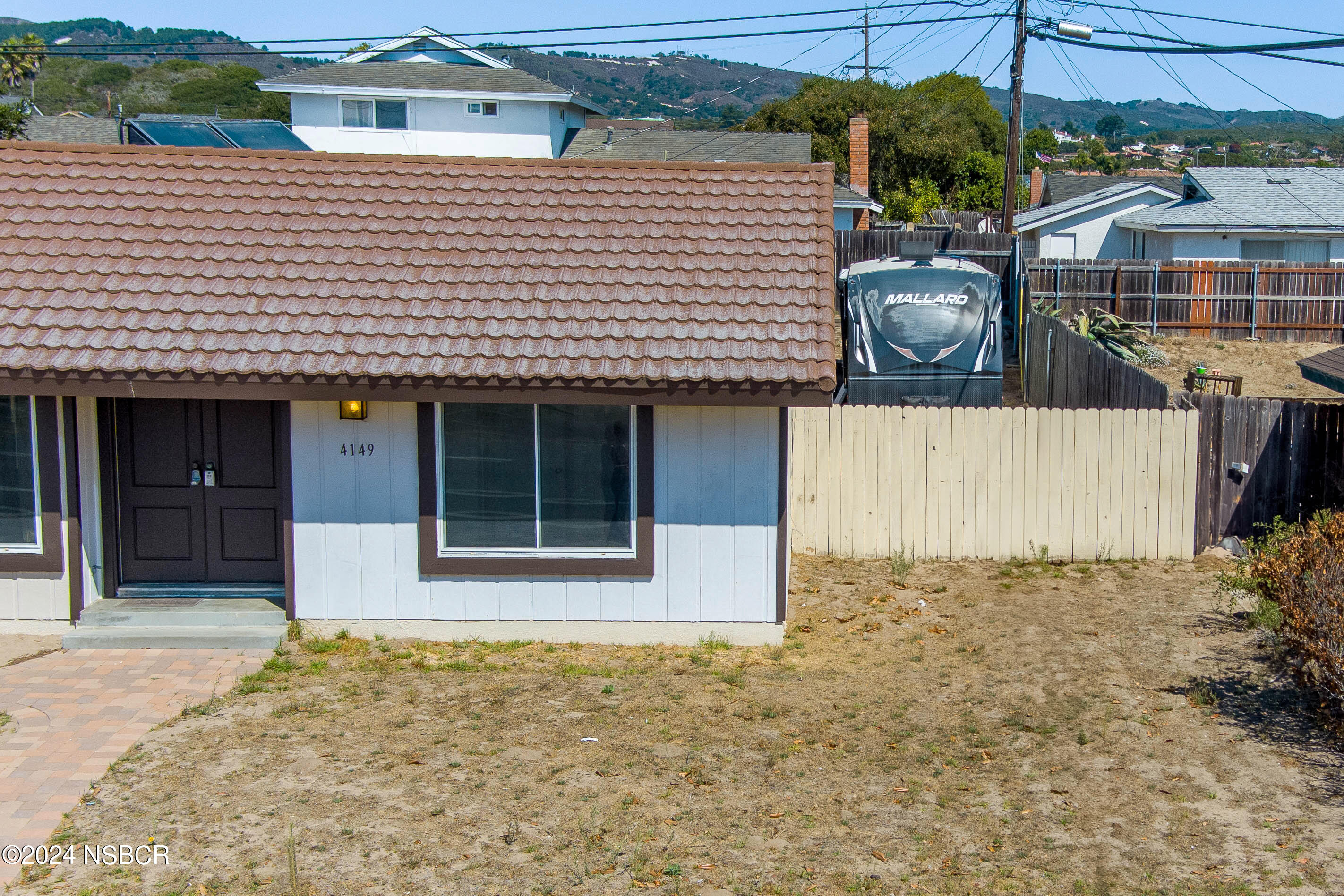 4149 Constellation Road Lompoc, CA 93436 - Photo 4 of 31 a front view of a house with a garden