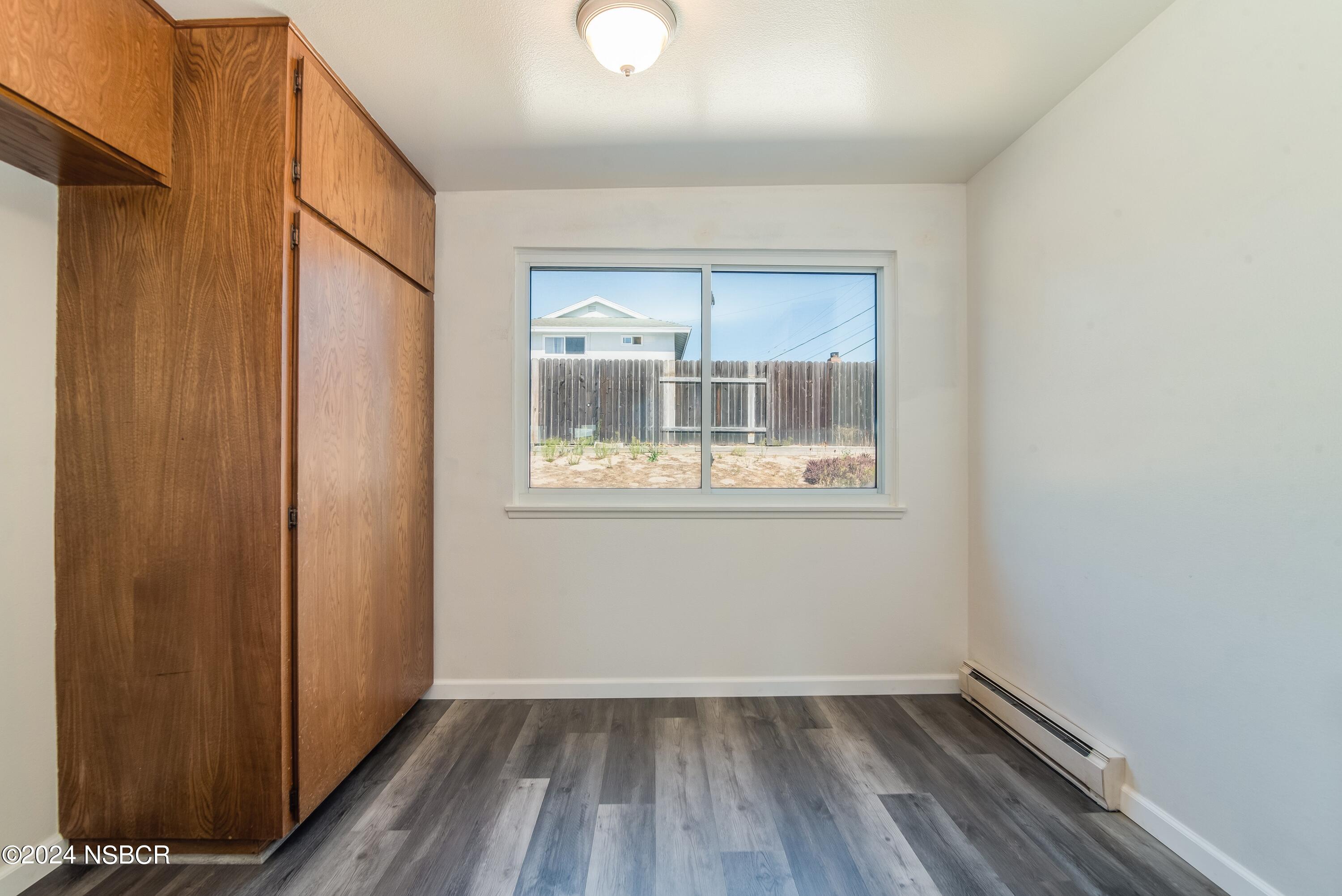 4149 Constellation Road Lompoc, CA 93436 - Photo 8 of 31 a view of an empty room with wooden floor and a window