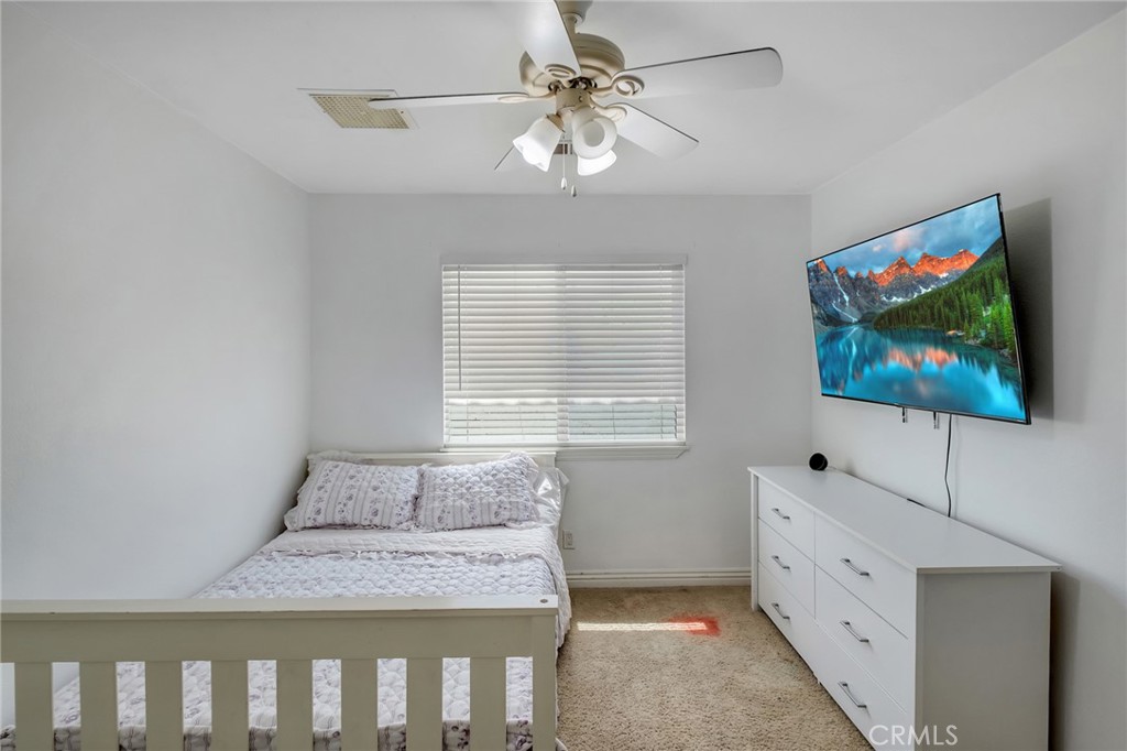 14952 Rivers Edge Road Helendale, CA 92342 - Photo 13 of 33 a bedroom with a bed and a flat screen tv