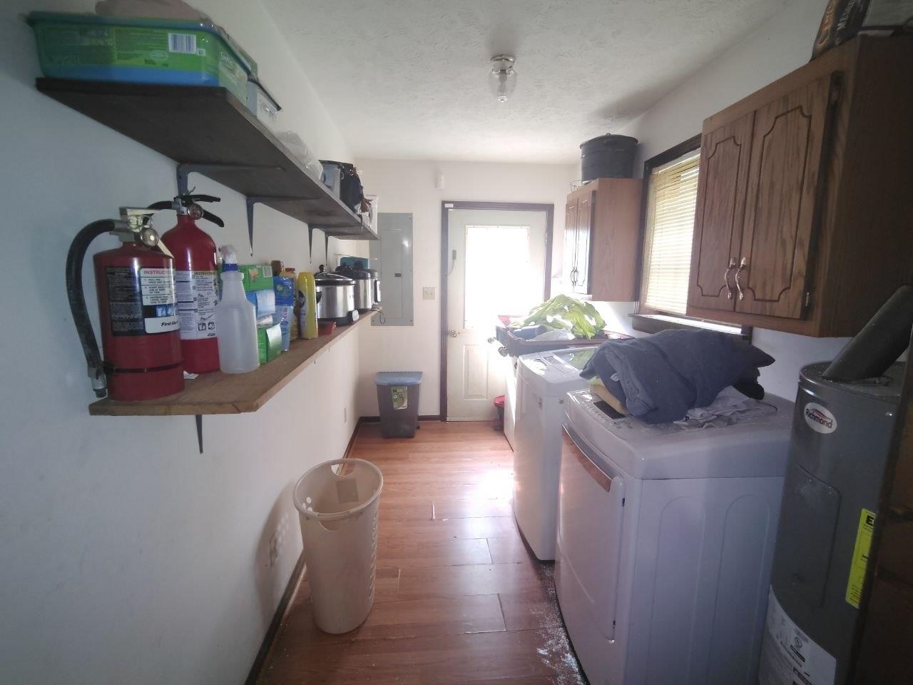 1475 Authur Byrd Road Pocahontas, TN 38061 - Photo 11 of 37 Utility space with wood-finish flooring, overhead ceiling light, built-in shelving, and upper wood cabinetry