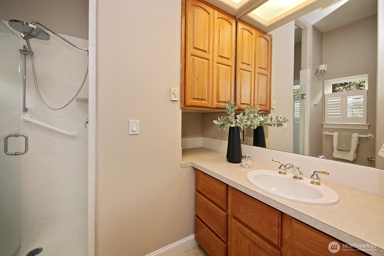 4694 Wrightsman Place Clinton, WA 98236 - Photo 21 of 38 a bathroom with a double vanity sink a mirror and a shower