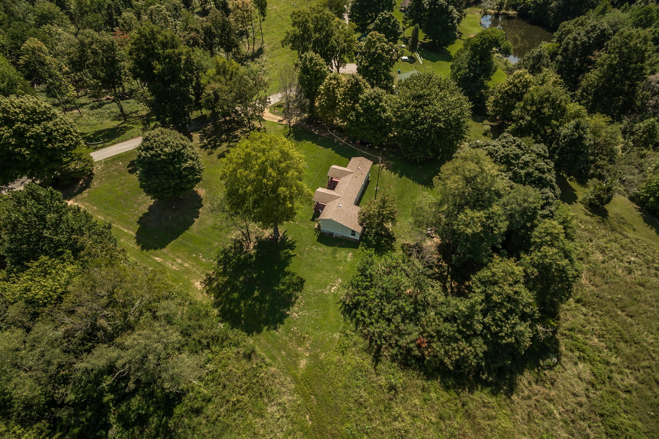 1560 Reese Road Bethpage, TN 37022 - Photo 2 of 22 an aerial view of residential house with outdoor space and trees all around
