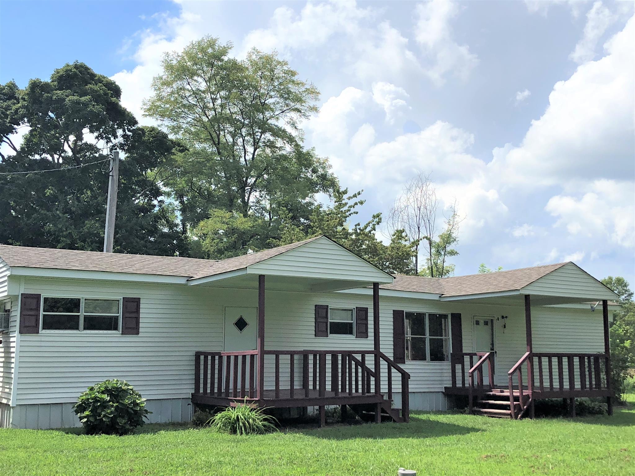 1560 Reese Road Bethpage, TN 37022 - Photo 13 of 22 a view of a house with a yard deck and a large tree