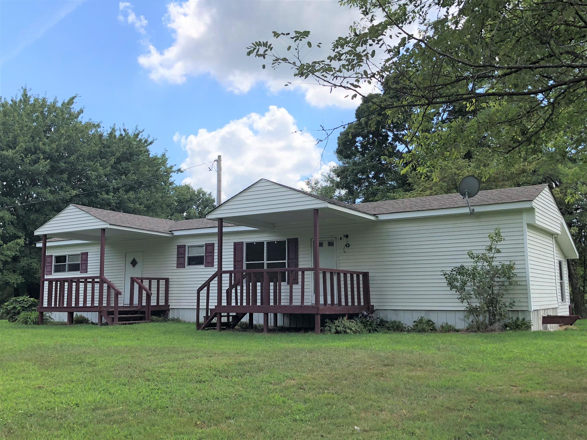 1560 Reese Road Bethpage, TN 37022 - Photo 14 of 22 a view of a house with a yard and a deck