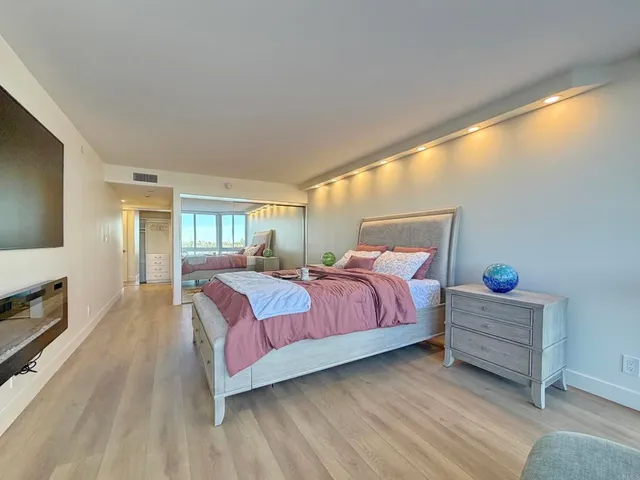 a bed room with a bed and a tv