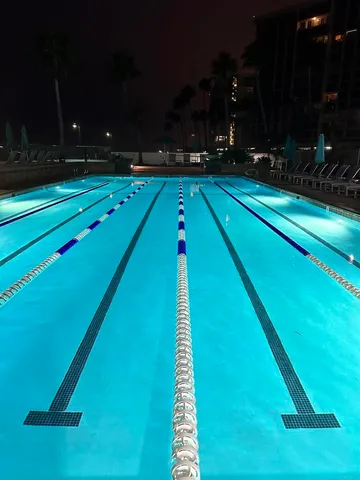 a swimming pool with wooden fence