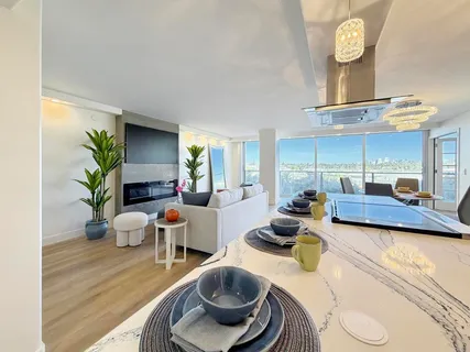 a living room with furniture a rug and a window