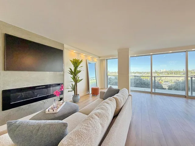 a living room with furniture and a floor to ceiling window