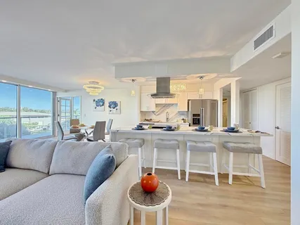 a living room with furniture a dining table and a fireplace