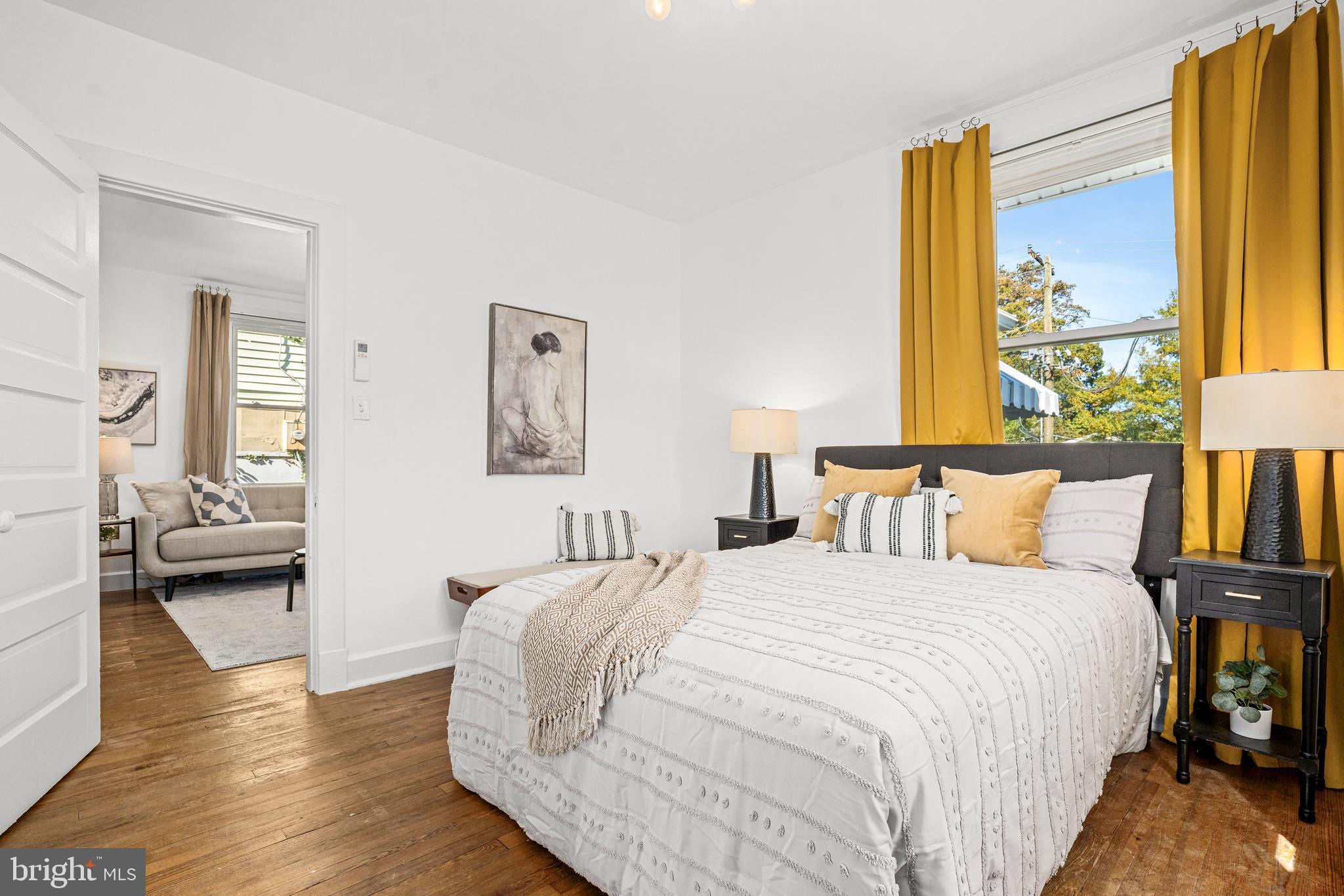 1327 Irving Street Northeast Washington, DC 20017 - Photo 20 of 39 a bedroom with a bed and wooden floor